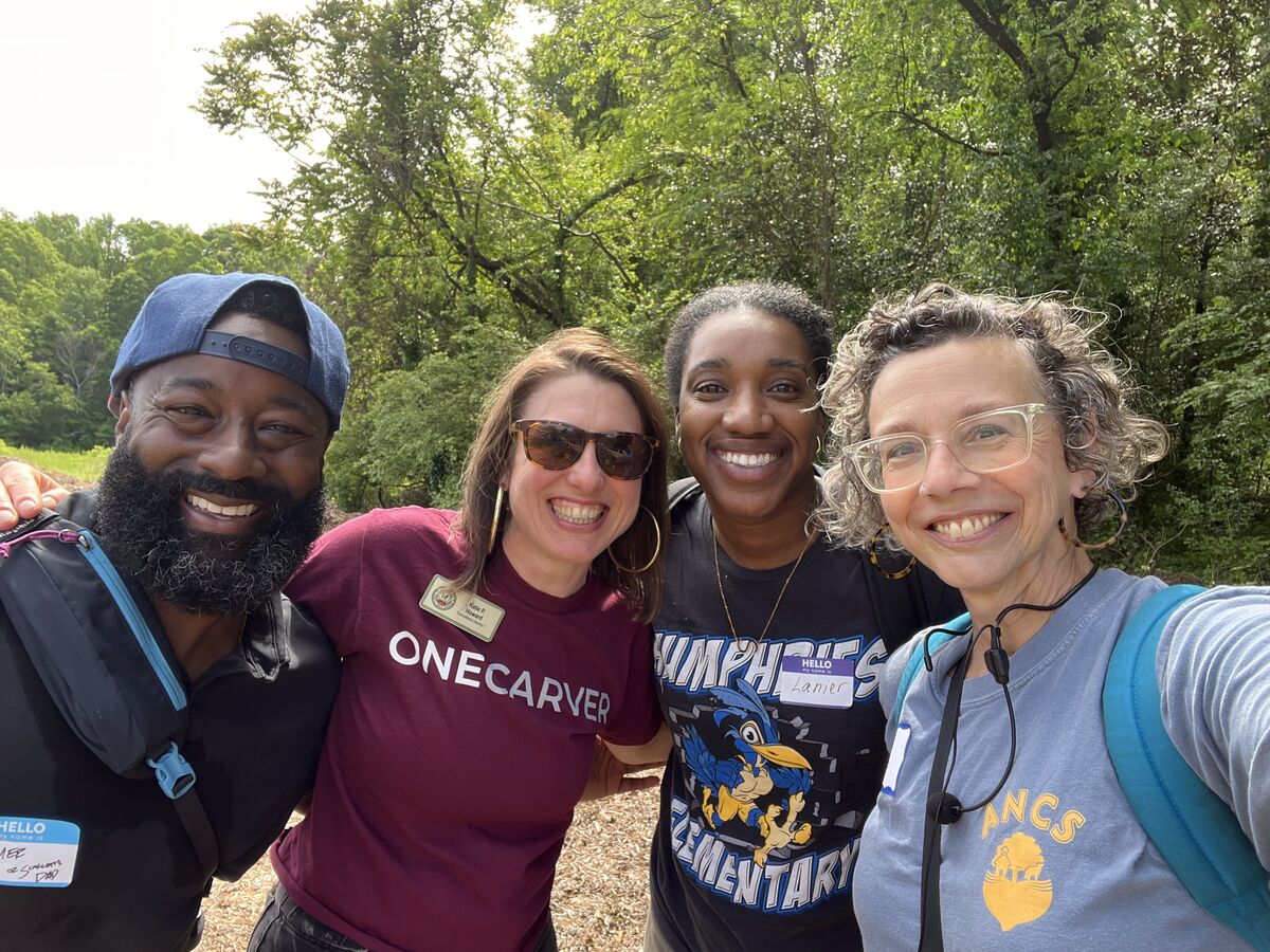 Mark Boswell with APS board member Katie Howard and lead educators from Humphries Elementary and ANCS, smiling together on the farm